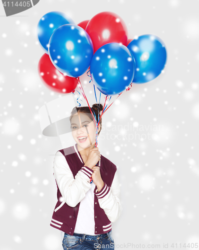 Image of happy teenage girl with helium balloons over snow