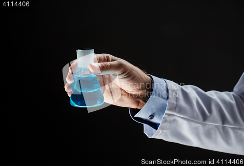 Image of close up of scientist holding flask with chemical