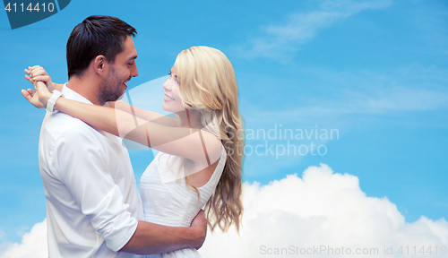 Image of happy couple hugging over blue sky and cloud