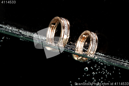Image of Golden Rings In The Water