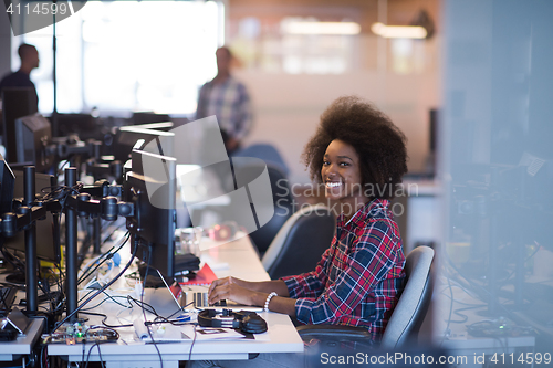 Image of young black woman at her workplace in modern office