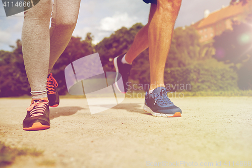 Image of close up of couple running outdoors