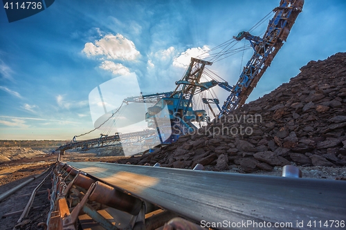 Image of Long conveyor belt transporting ore