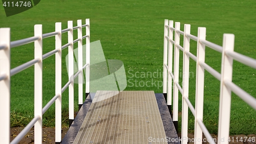 Image of White fence on path