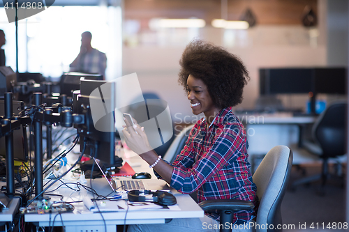 Image of young black woman at her workplace in modern office