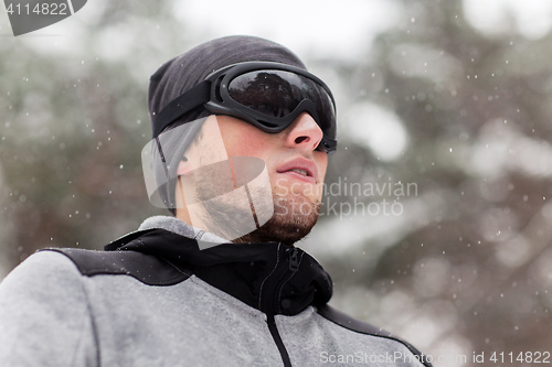 Image of sports man with ski goggles in winter outdoors