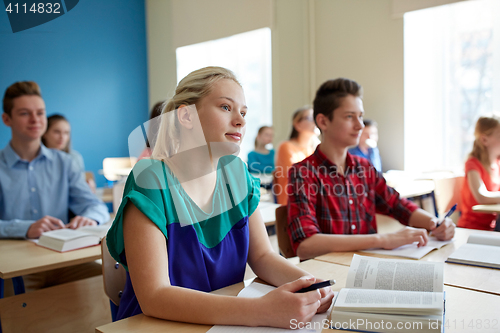 Image of group of students with books at school lesson