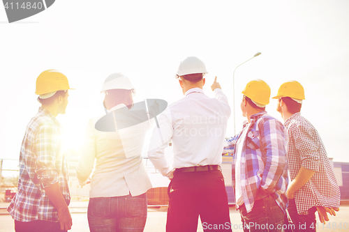 Image of group of builders and architects at building site