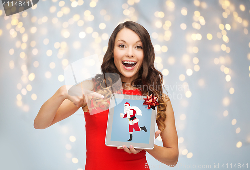Image of woman s with santa claus on tablet pc screen