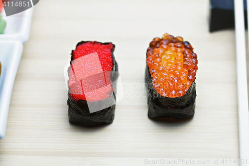 Image of Tobiko and Ikura sushi on table