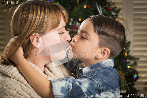 Image of Mother and Mixed Race Son Hug Near Christmas Tree