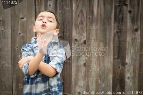 Image of Young Mixed Race Boy Making Hand Gestures