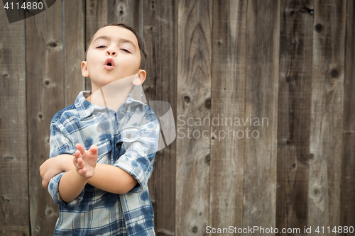 Image of Young Mixed Race Boy Making Hand Gestures