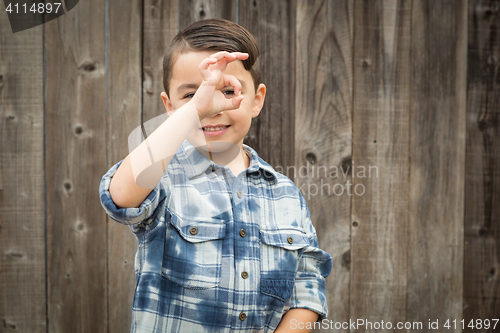Image of Young Mixed Race Boy Making Hand Gestures