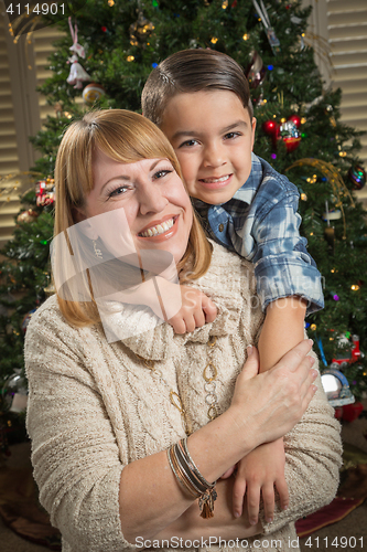 Image of Mother and Mixed Race Son Hug Near Christmas Tree