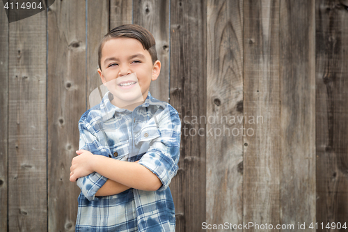 Image of Young Mixed Race Boy Portrait Against Fence