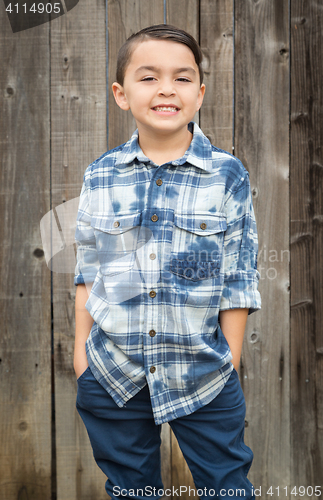 Image of Young Mixed Race Boy Portrait Against Fence