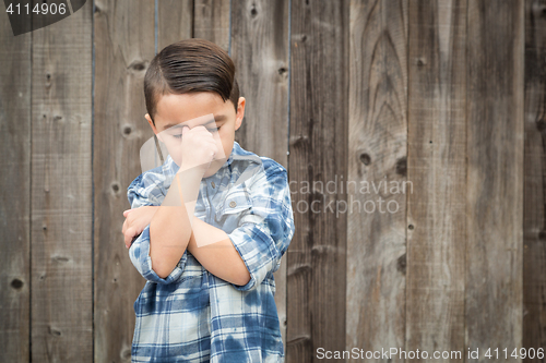 Image of Frustrated Mixed Race Boy With Hand on Face