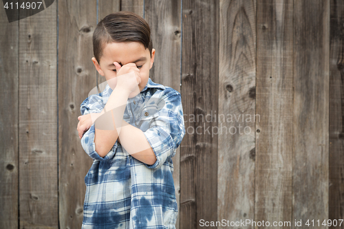 Image of Frustrated Mixed Race Boy With Hand on Face