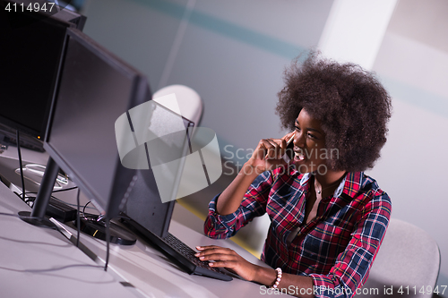 Image of young black woman at her workplace in modern office