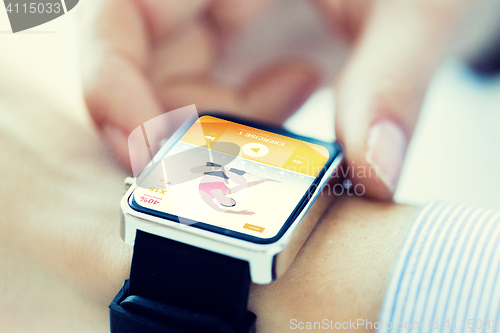 Image of close up of hands setting sport app on smartwatch