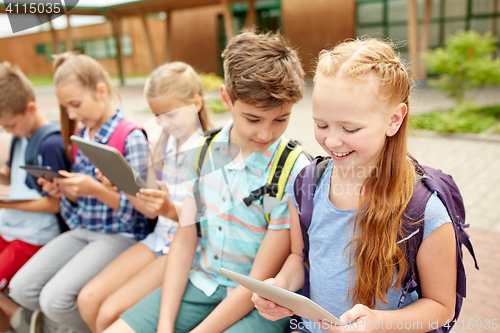 Image of group of happy elementary school students talking