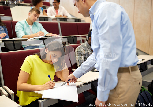 Image of group of students and teacher with notebook