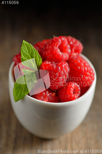 Image of ripe and fresh raspberry in white cup 