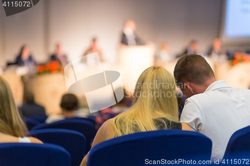 Image of Audience in lecture hall participating at business conference.