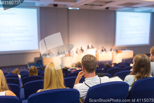 Image of Audience in lecture hall participating at business conference.