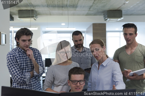 Image of group of young startup business people standing as team