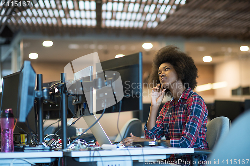 Image of young black woman at her workplace in modern office