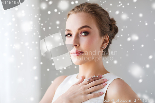 Image of beautiful woman in white with diamond jewelry