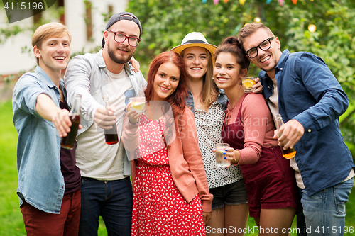 Image of happy friends with drinks at summer garden party