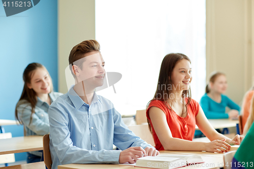 Image of group of students with notebooks at school lesson