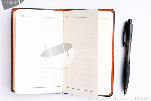 Image of notepad with pen isolated