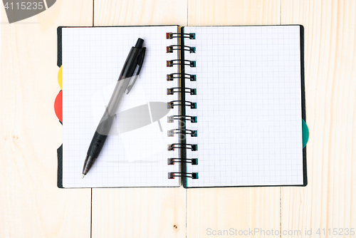 Image of notepad with pen isolated