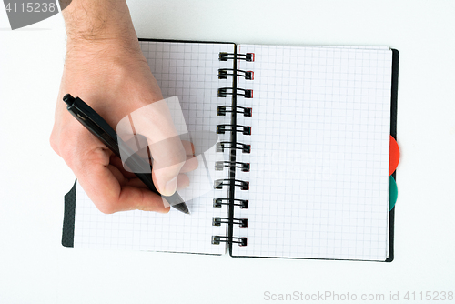 Image of Hand writing on empty notepad