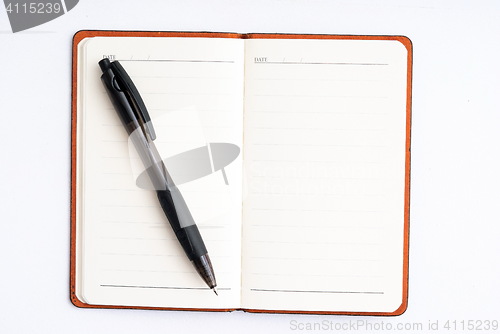 Image of notepad with pen isolated