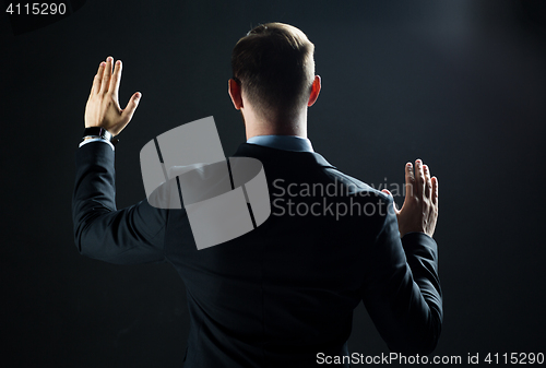 Image of businessman touching virtual screen