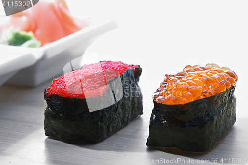 Image of Tobiko and Ikura sushi with ginger closeup