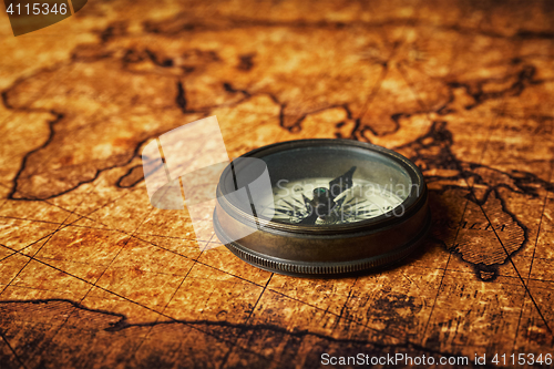 Image of Old vintage compass on ancient map
