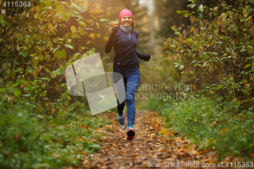 Image of Blond girl running among trees