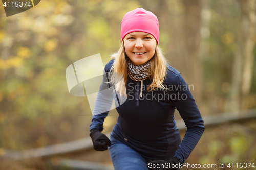 Image of Beautiful sportswoman running in park