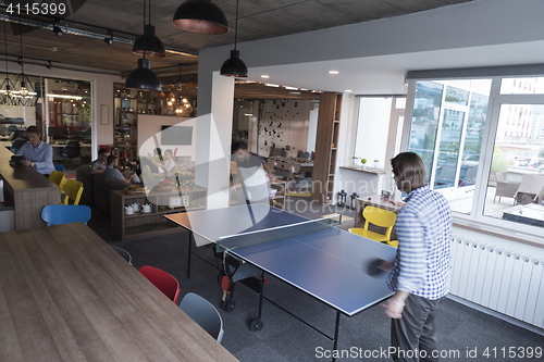 Image of playing ping pong tennis at creative office space