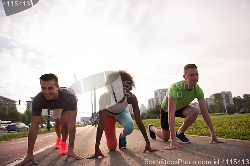 Image of multiethnic group of people on start position for jogging