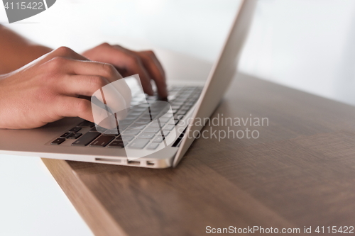 Image of close up of male hands while working in modern office