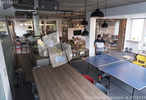 Image of playing ping pong tennis at creative office space