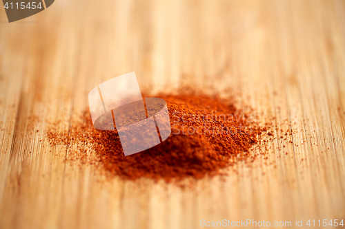 Image of cayenne pepper or paprika powder on wood