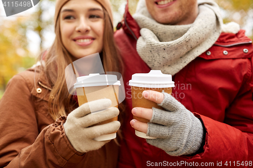 Image of close up of happy couple with coffee in autumn